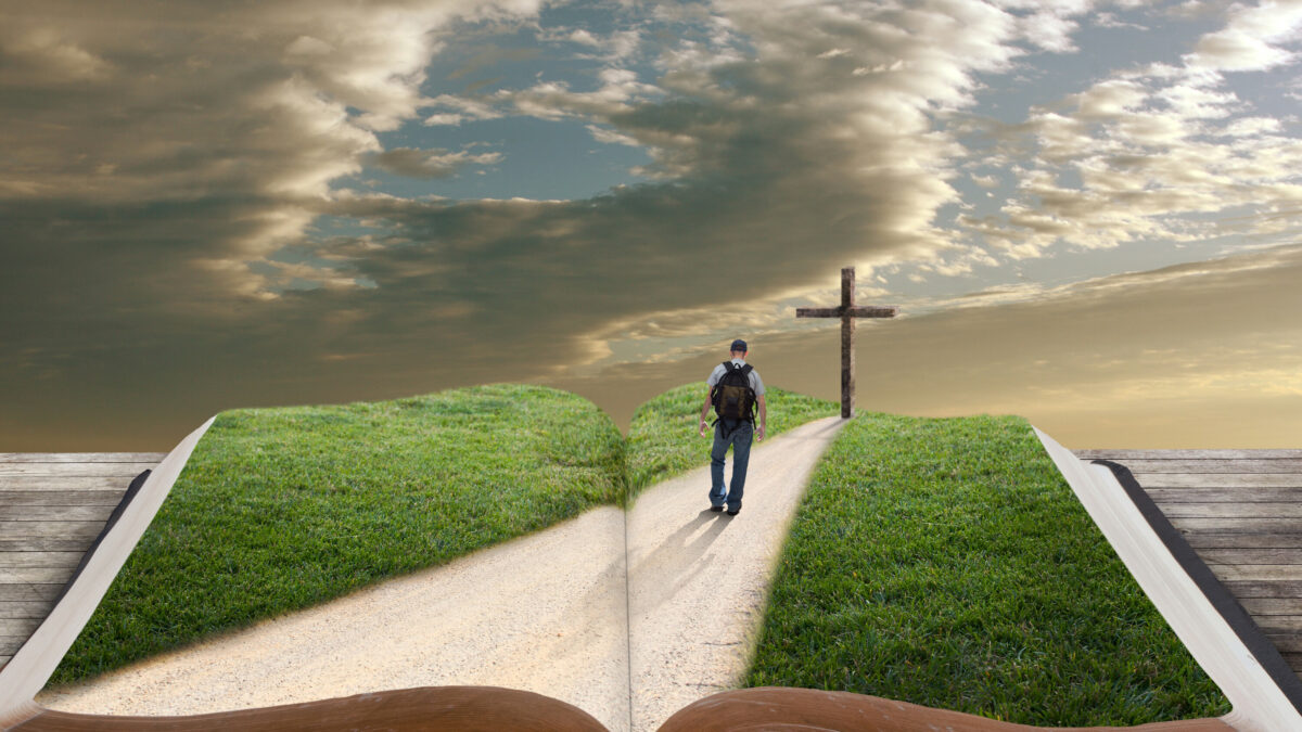 Man walking toward cross